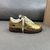 Louis Vuitton x Nike Air Force 1 Low By Virgil Abloh Metallic Gold Sneakers: A pair of metallic gold sneakers, part of the collaboration between Louis Vuitton and Nike, designed by Virgil Abloh.