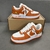 Louis Vuitton x Nike Air Force 1 Low By Virgil Abloh Orange/White Sneakers: A pair of orange and white sneakers, the result of a collaboration between Louis Vuitton and Nike with an exclusive design by Virgil Abloh.