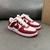 Louis Vuitton x Nike Air Force 1 Low By Virgil Abloh Red/White Sneakers: A pair of red and white sneakers, part of the collaboration between Louis Vuitton and Nike, created by Virgil Abloh.