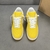 Louis Vuitton x Nike Air Force 1 Low By Virgil Abloh Yellow Sneakers: A pair of yellow sneakers from the collaboration between Louis Vuitton and Nike, designed by Virgil Abloh.