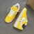 Louis Vuitton x Nike Air Force 1 Low By Virgil Abloh Yellow Sneakers: A pair of yellow sneakers from the collaboration between Louis Vuitton and Nike, designed by Virgil Abloh.