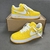 Louis Vuitton x Nike Air Force 1 Low By Virgil Abloh Yellow Sneakers: A pair of yellow sneakers from the collaboration between Louis Vuitton and Nike, designed by Virgil Abloh.