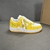 Louis Vuitton x Nike Air Force 1 Low By Virgil Abloh Yellow/White Sneakers: A pair of yellow and white sneakers, the result of a collaboration between Louis Vuitton and Nike with an exclusive design by Virgil Abloh.