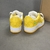 Louis Vuitton x Nike Air Force 1 Low By Virgil Abloh Yellow/White Sneakers: A pair of yellow and white sneakers, the result of a collaboration between Louis Vuitton and Nike with an exclusive design by Virgil Abloh.