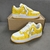 Louis Vuitton x Nike Air Force 1 Low By Virgil Abloh Yellow/White Sneakers: A pair of yellow and white sneakers, the result of a collaboration between Louis Vuitton and Nike with an exclusive design by Virgil Abloh.