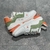 LV Trainer White/Green/Orange Sneakers: A sporty style sneaker, with details in green and orange, perfect for an urban and modern look.