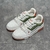 LV Trainer White/Green/Orange Sneakers: A sporty style sneaker, with details in green and orange, perfect for an urban and modern look.