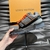 LV Trainer Maxi Black/Gray/Orange sneakers: Features a sneaker with a predominance of black and gray, highlighted by orange details. A modern and versatile design for any style.