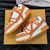 LV Trainer Maxi Orange/White Sneakers: Vibrant combination of orange and white, providing a modern and stylish look for any occasion.