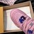 LV Trainer Maxi Pink Sneakers: Presents a pair of pink sneakers, standing out for their vibrant hue, ideal for those looking for a modern and stylish look.