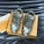 LV Trainer Maxi Damoflage Khaki Green Sneakers: Shows a pair of sneakers with a camouflage print in shades of military green, a striking and urban style for those looking for a modern and relaxed look.