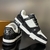 LV Trainer Monogram Denim Black/White Sneakers: These Louis Vuitton sneakers feature black and white monogram denim details for a sleek, contemporary look.