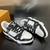 LV Trainer Monogram Denim Black/White Sneakers: These Louis Vuitton sneakers feature black and white monogram denim details for a sleek, contemporary look.