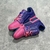 Pink/Purple LV Trainer Tie-Dye Sneakers: A cool shoe with a tie-dye pattern in shades of pink and purple, ideal for a vibrant and stylish look.