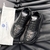 Versace Odissea Slashed "Black" Sneakers: A pair of Versace Odissea Slashed sneakers in black, with cut-out details and a chunky sole, displaying elegance and modern style.