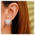 Brinco Ear Cuff Base Oval Com Raios Cravejados E Pedra Central Zirconia Branca Em Rodio Branco - comprar online