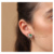 Brinco Ear Cuff Base Oval Com Raios Cravejados E Pedra Central Zirconia Esmeralda Em Rodio Branco - comprar online