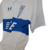 Imagem do Camisa Universidad Católica I 23/24 - Torcedor Under Armour Masculina - Branca com detalhes em azul e vermelho