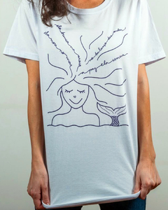 camiseta branca com desenho de uma sereia, com a frase "ela mora no mar, ela brinca na areia, no balanço das ondas a paz ela semeia", em tamanho adulto, sem gênero