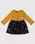 Vestido infantil com aplique de malha algodão, parte superior em amarelo com estampa de rosto sorridente e saia preta com flores coloridas. VALENTINA MODA