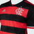 Camisa I Flamengo 24/25 Torcedor Adidas Masculina nas cores preto e vermelho, com listras horizontais e escudo do clube.