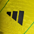 Camisa Jamaica I 23/24 - Jogador Adidas Masculina - Amarela com detalhes verde e preto - CAMISAS DE FUTEBOL | Olé FutStore