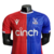 Camisa Crystal Palace I 23/24 - Jogador Macron Masculina - Vermelha e azul com detalhes em branco na internet