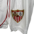 Kit Infantil Sevilla I Castore 23/24 - Branco com detalhes em vermelho en internet