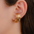 Brinco Piercing Unitario Ear Hook com Estrelinhas Olho Grego e Florzinhas no Dourado com Multicor