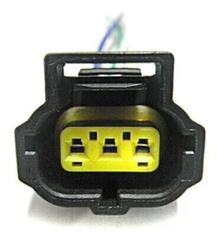 Conector de arnés de regulador de alternador Ford, con terminales amarillos y cables visibles.