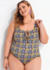 Maiô plus size estampado com margaridas e poá, usado por uma mulher sorridente, ideal para o verão.