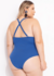 Modelo plus size de maiô azul visto de costas, com alças cruzadas e detalhes em tecido canelado.