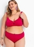 Modelo plus size usando uma calcinha biquíni pink de cintura alta em malha fria, sorrindo e com brincos coloridos.