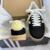 Tênis ADIDAS GAZELLE INDOOR na cor preto com detalhes em amarelo, modelo com três listras laterais e sola translúcida.