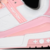 Tênis Louis Vuitton Trainer nas cores branca e rosa, com detalhes em couro e sola esportiva.