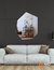 Hepta-shaped mirror reflecting a stylish living room with a black wall and modern decor.