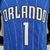 Camiseta regata azul do Orlando Magic, destacando o nome "ORLANDO" e o número 1 na parte de trás.