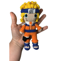 Detalhe do rosto do boneco de Naruto em Amigurumi, com expressão determinada e marcas de bigode características do personagem.