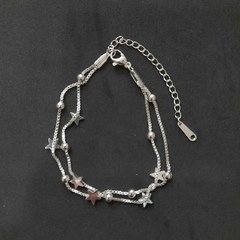 Pulsera de acero quirúrgico blanco con dijes de estrellas