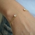 Bracelete Dourado Torcido Pontas Zircônias - comprar online