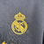 Camisa preta do Real Madrid III 2023/2024 para torcedores masculinos, com detalhes em dourado.