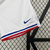 Calção branco masculino da seleção da França, Nike, com logo e detalhes em azul e vermelho.