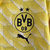 Agasalho corta vento amarelo do Borussia Dortmund, modelo dupla face da Puma, com logotipo e design moderno.