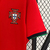 Camisa vermelha da seleção de Portugal, modelo 2024/25, fabricada pela Nike, com logo da marca e emblema da seleção.