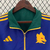 Agasalho corta vento Roma Dupla Face da Adidas, nas cores verde e azul, com detalhes em amarelo e logo da marca.