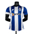 Camisa masculina do FC Porto para a temporada 2023/2024, em azul e branco, modelo jogador da New Balance.