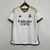 Camisa branca do Real Madrid I 2023/2024 para torcedores masculinos da Adidas, com detalhes em dourado e logo da equipe.