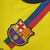 Camisa retrô amarela do Barcelona, temporada 2008/2009, com logo da Nike e detalhes em vermelho e azul.