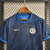 Camisa masculina do Chelsea II 2023/2024, fabricada pela Nike, em azul com detalhes em preto e azul claro.