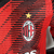 Camisa de jogador masculina do AC Milan 2023/2024 na cor vermelha, com detalhes em preto e logo da Puma.